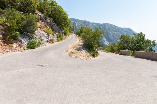 Curve on winding road in Biokovo mountains, Croatia.