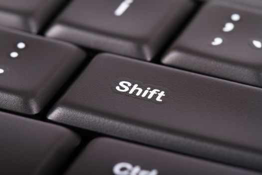 Close up view of shift button on black computer keyboard.