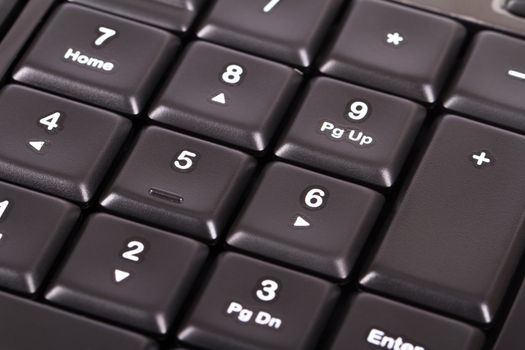 Black computer keyboard keys on numpad area.