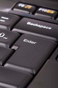 Enter key on black keyboard.