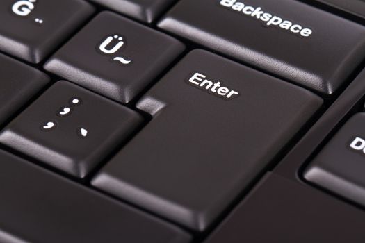 Enter button on black keyboard.