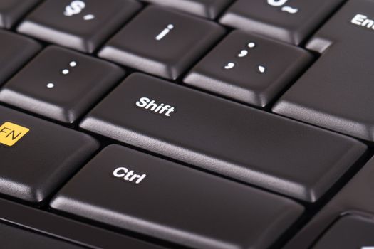 Black keyboard, focused on shift key.