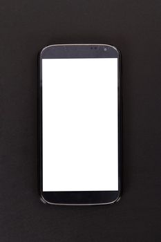 Smart phone with blank, white screen, top view on wooden table.