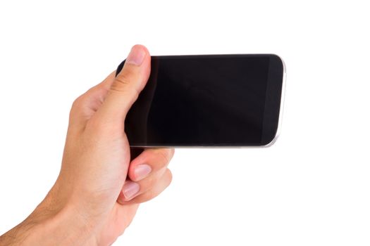 Hand holding and showing smart phone with blank, dark screen, front view, isolated on white background.