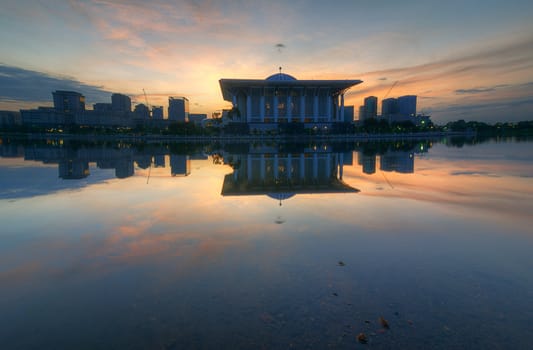 Ray of sunrise behind the mosque.