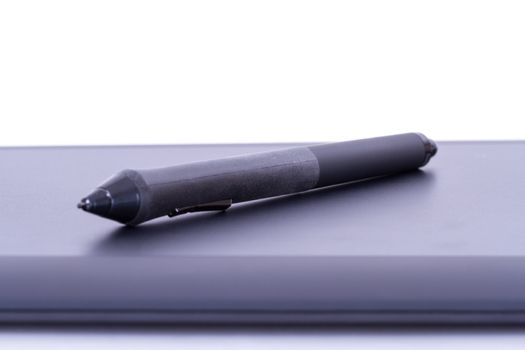 Digital pen on graphic tablet, isolated on white background.