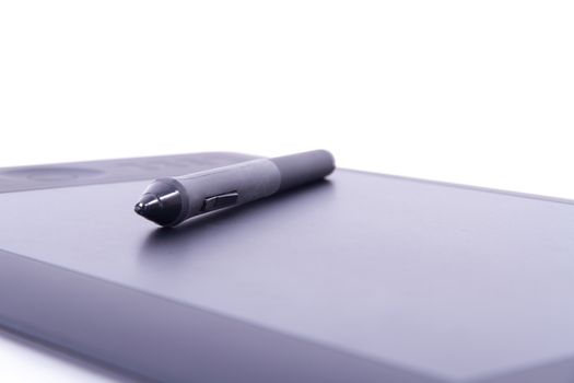 Digital pen on graphic tablet with depth of field, isolated on white background.