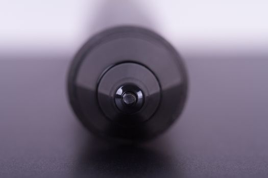 Focused on digital graphic pen point on tablet with depth of field.