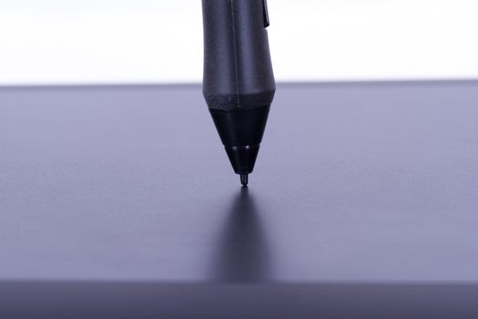 Pen on digital graphic tablet, isolated on white background.