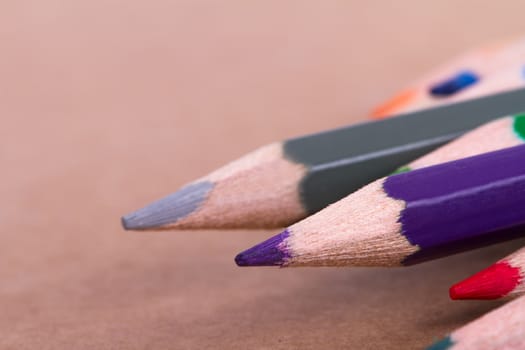 Colorful pencils on textured background.