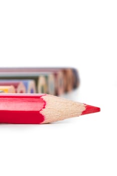 Colorful pencils, focused on red pencil, isolated on white background.