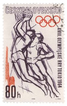 CZECHOSLOVAKIA - CIRCA 1963: A stamp printed in Czechoslovakia, shows basketball players fighting for the ball, devoted to Olympics in Tokyo, series, circa 1963