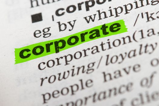 Corporate word highlighted with green marker on dictionary page.