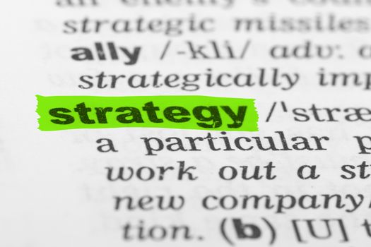 Strategy word highlighted with green marker on dictionary page.