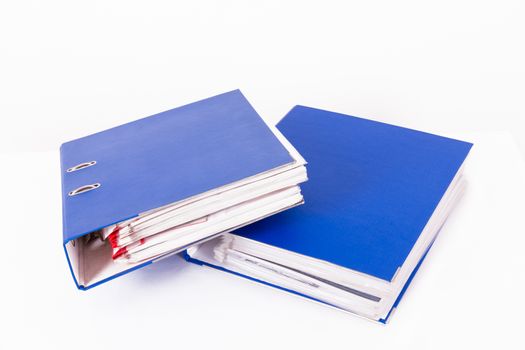 Stack of blue office folders, isolated on white background.