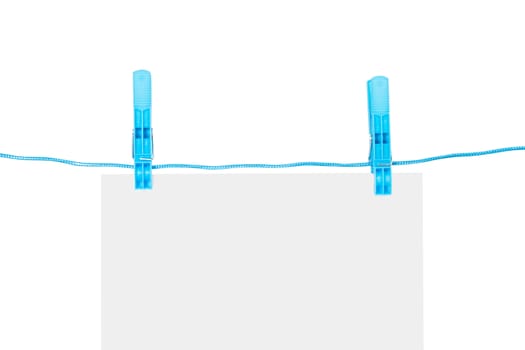 White, blank paper on rope with blue, plastic clothespin, isolated on white background.