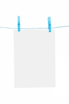 White, blank paper on rope with blue, plastic clothespin, isolated on white background.