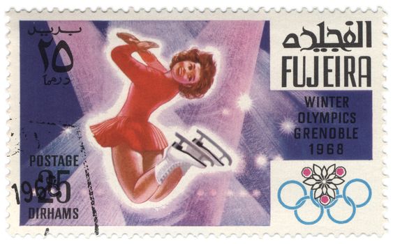 Fujeira - CIRCA 1968: A stamp printed in Fujeira shows women's figure skating, devoted to the Winter Olympic Games in Grenoble, series, circa 1968