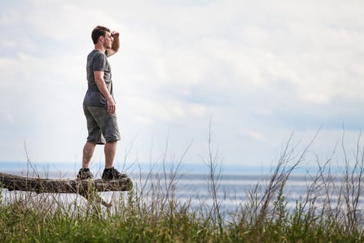 Young Adult in Nature Looking at The View With the Ocean in Background