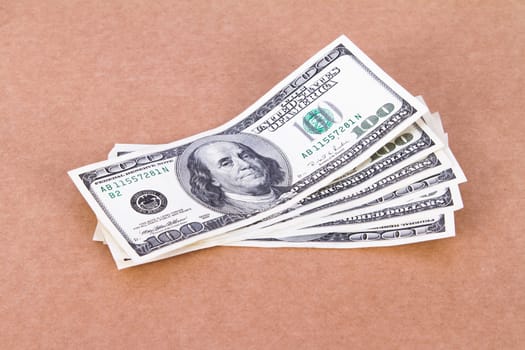 Money concept, one hundred dollar bills on cork board.