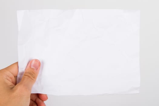Hand holding grunged, crumpled, blank paper, isolated on white background.