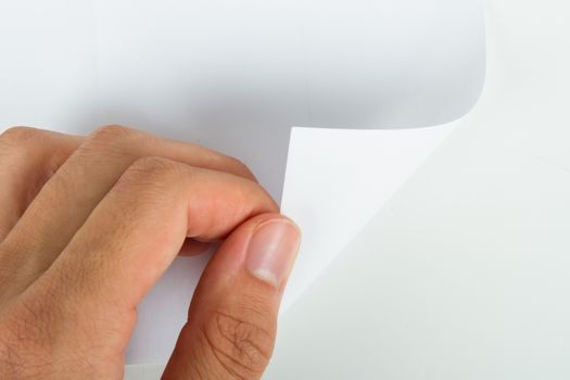 Hand turning blank page, isolated on white background.