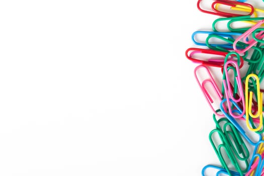 Multi colored paper clips with space, isolated on white background.