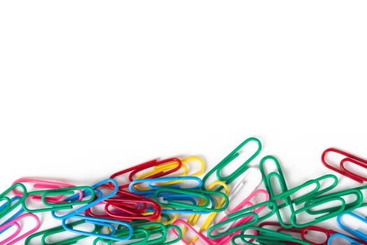 Multi colored paper clips with space, isolated on white background.