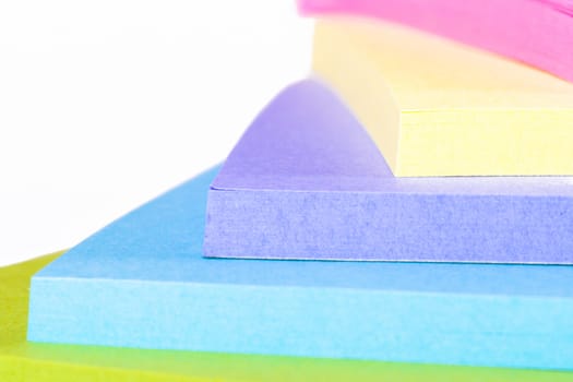Multi colored sticky post it notes, isolated on white background.