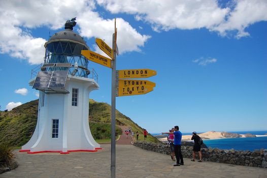 Yellow tourist sign at near old vintage lighthouse, Cape Reinga, New Zealand