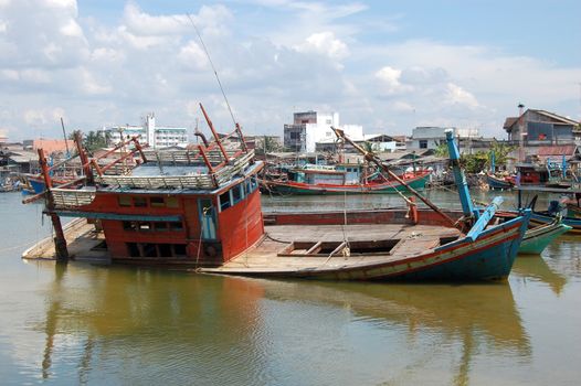 Abandoned drowned timber ship at port, Southern Thailand