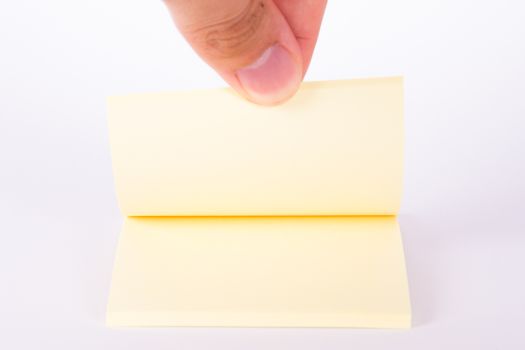 Blank, yellow sticky post block for your message, isolated on white background.