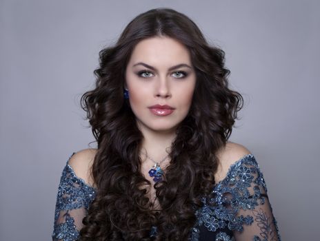 Beautiful young woman in gray background