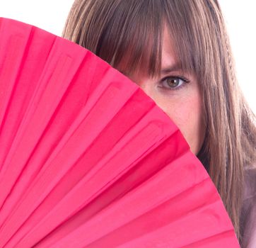 Studio portrait of a womans face partly hidden by a fan, isolated on white