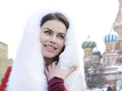 Portrait of a young woman on the background of a winter city