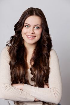 Beautiful young woman in gray background