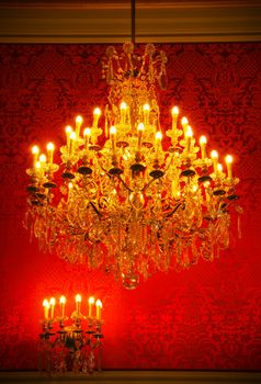 Real lavish crystal chandelier of French castle with tapestry and gold trim