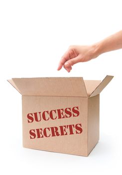 Hand reaching into a box labeled success secrets 