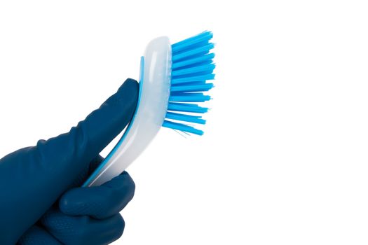 Hand in rubber glove holding blue brush for cleaning, isolated on white background.