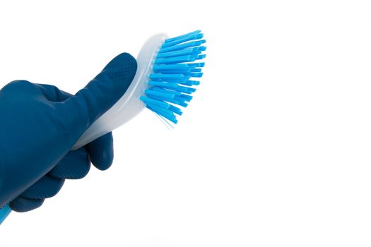 Hand in rubber glove holding blue brush for cleaning, isolated on white background.