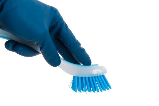 Hand in rubber glove holding blue brush for cleaning, isolated on white background.