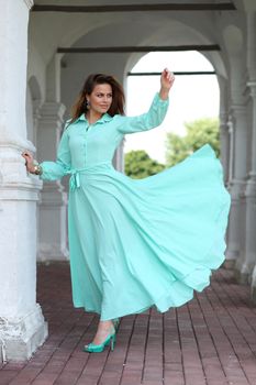 Portrait in full growth, attractive young woman in green dress