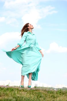 Portrait in full growth, attractive young woman in green dress