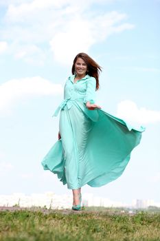 Portrait in full growth, attractive young woman in green dress