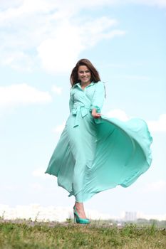 Portrait in full growth, attractive young woman in green dress