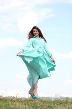 Portrait in full growth, attractive young woman in green dress