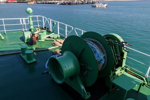 Winch with rope on ferry dropping anchor forward mooring station