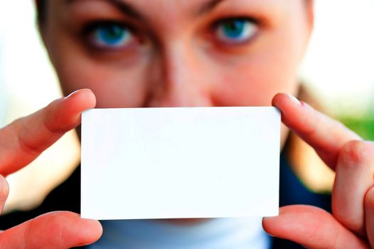 A girl showing a blank business card