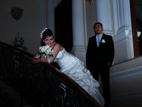  bride and groom standing on the stairs.
