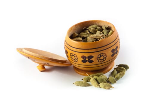 Pile of whole cardamom on white background